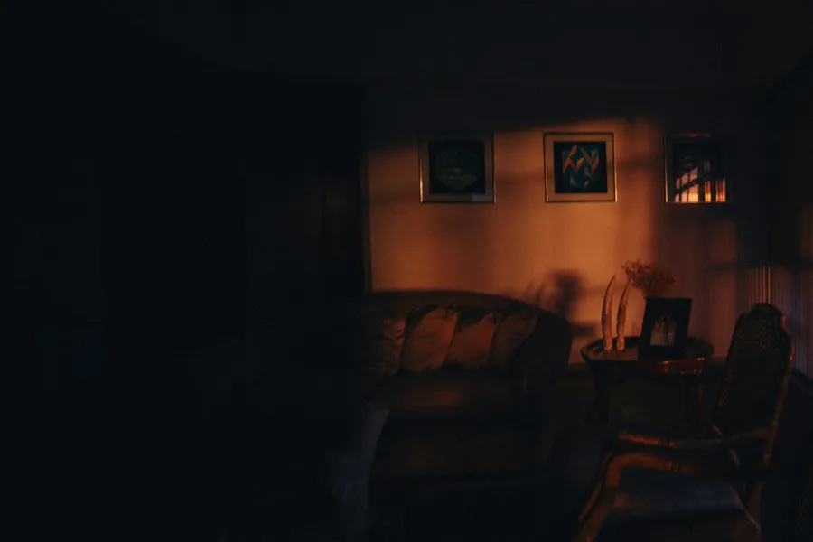 A softly lit living room at night with a lamp glowing
